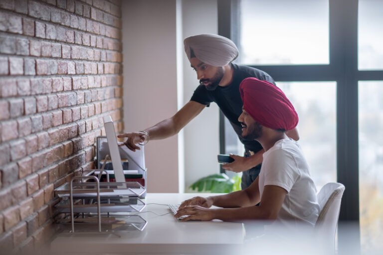 Two indian men discussing something and looking involved